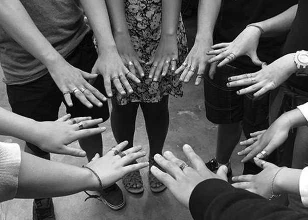 circle of hands with rings on them